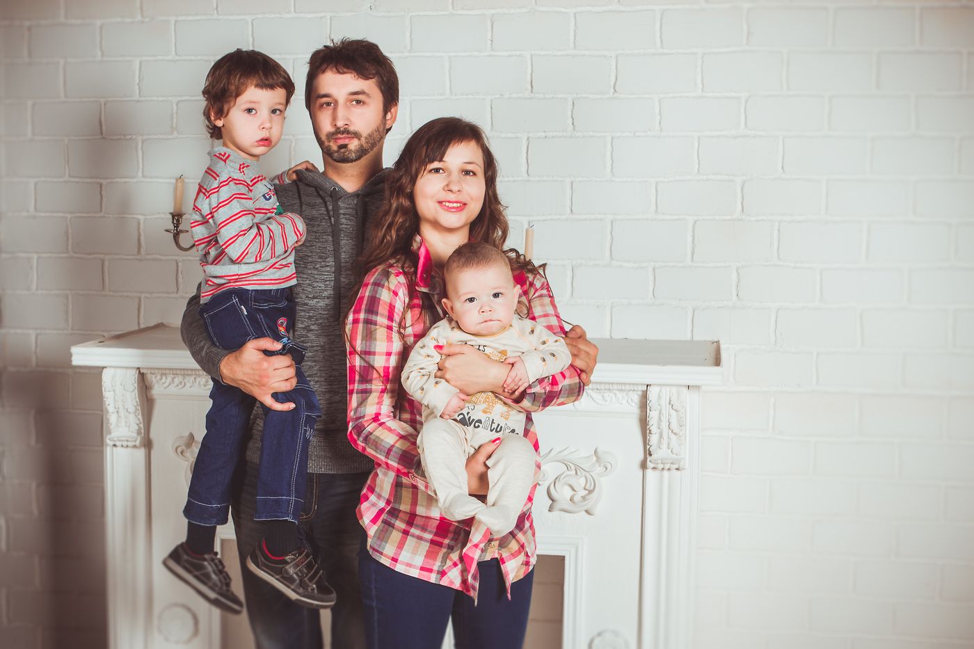 Parents holding their two young children